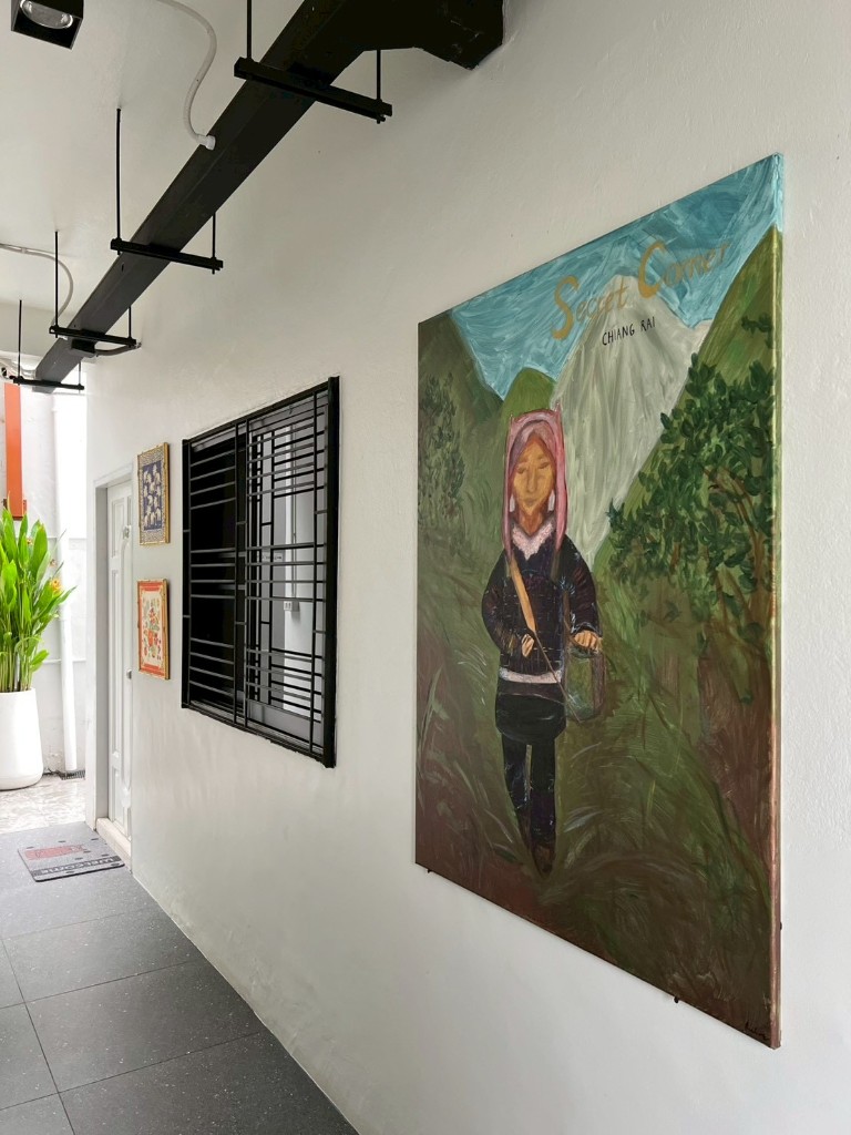 Secret Corner painting installed in a white hallway